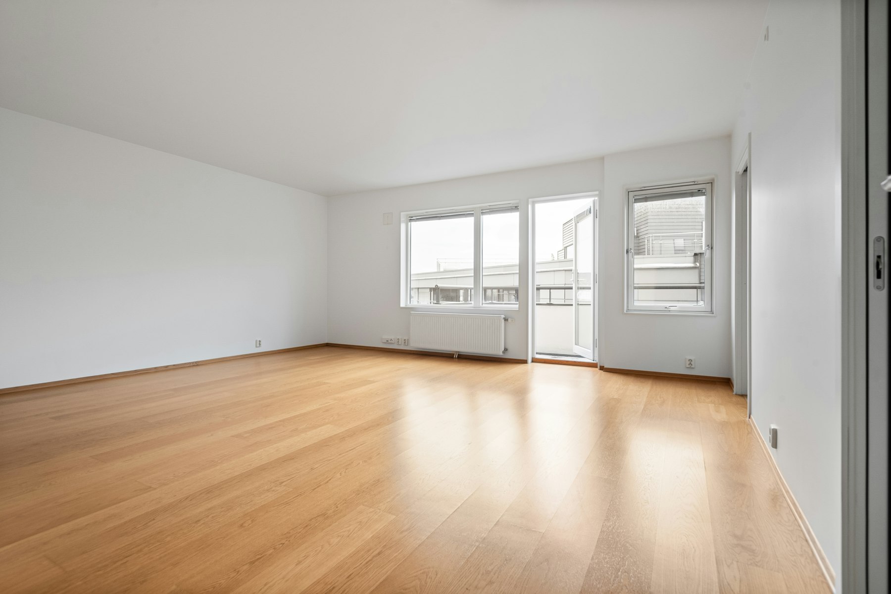 An empty, freshly cleaned flat with pale wooden floors